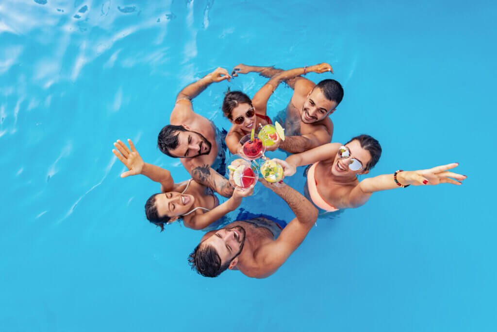 friends toasting to free pool service for referring each other to nationwide pools for pool cleaning